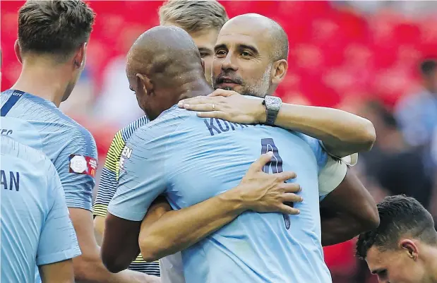  ?? GETTY IMAGES ?? Manchester City manager Pep Guardiola embraces Vincent Kompany after the defending Premier League champs ran all over Chelsea to win last Sunday’s Community Shield contest. Guardiola says he prepared for the friendly as if it were a Champions League final.