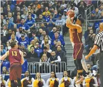  ?? THE ASSOCIATED PRESS ?? Loyola-Chicago guard Marques Townes makes a 3-point shot under pressure late in the game against Nevada during a regional semifinal game Thursday in Atlanta. Loyola won 69-68.