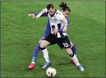  ??  ?? In this March 8, 2020 file photo, Fiorentina’s Martin Caceres and Udinese’s Ilija Nestrovski, foreground, vie for the ball during the Italian Serie A soccer match between Udinese and Fiorentina, at the Dacia Arena stadium in
Udine, Italy. (AP)