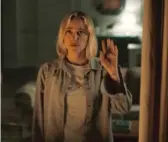  ?? IFC MIDNIGHT ?? Every time Julia (Maika Monroe) looks out the window, she sees the same shadowy figure staring back in “Watcher.”