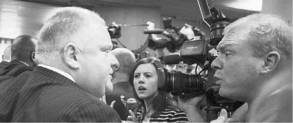  ?? Chris Young / the Cana dian press ?? Toronto Mayor Rob Ford confronts a television cameraman as he tries to escort his wife out of a news conference on Thursday.