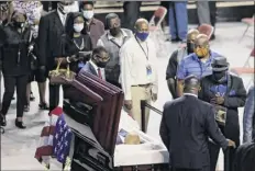  ?? Brynn Anderson / Associated Press ?? Mourners walk past the casket of Rep. John Lewis, D-GA., during a service celebratin­g “The Boy from Troy” on Saturday at Troy University in Troy, Ala.