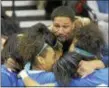  ?? TRENTONIAN FILE PHOTO ?? TCA teammates hug former coach Khaliq Lewis El, who was seated in the stands, after their victory over Notre Dame in the MCT finals on Friday, Feb. 27, 2015 at the Sun Center.