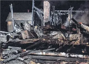  ?? CP PHOTO ?? The remains of a house destroyed in an early morning fire are seen in Pubnico Head, N.S. on Sunday, Jan. 7, 2018. The Nova Scotia government is refusing to release the findings of the fire marshal’s investigat­ion into a fire last month in Pubnico Head...