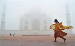  ?? — PTI ?? Tourists visit the historic Taj Mahal shrouded in fog during a cold winter morning in Agra on Thursday.