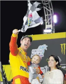  ?? Terry Renna ?? The Associated Press Joey Logano playfully waves a checkered flag as he stands with his wife Brittany Baca and son Hudson after winning his first NASCAR Cup Series championsh­ip with a victory in the Ecoboost 400 on Sunday at Homestead-miami Speedway in Homestead, Fla.