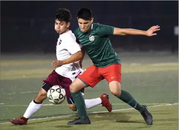  ?? RECORDER PHOTO BY CHIEKO HARA ?? Lindsay High School’s Moises Betencourt, right, battles for a ball Tuesday, Nov. 27, during the second half of a game against Mt. Whitney High School at Frank Skadan Stadium in Lindsay. Betencourt scored the game-winning goal towards the end of the second half.