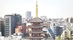  ?? — AFP photo ?? Sensoji temple is pictured against modern buildings in Tokyo’s Asakusa district. The trade surplus was chiefly due to a rise in exports of vehicles, machines for constructi­on and mining, and semiconduc­tor-making equipment, the ministry said.