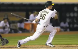  ?? Ben Margot / Associated Press ?? A’s rookie Matt Chapman, shown hitting a two-run single against the Yankees last Friday, is in the hospital with an infection in his left knee.