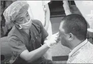  ?? PROVIDED TO CHINA DAILY ?? A doctor treats Zhao Xuecheng at the Third Hospital of Wuhan after removing bandages.