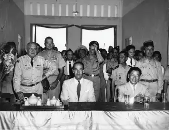  ??  ?? Edward Lansdale (second row, hand on hat) standing behind Lieutenant General John W. ‘Iron Mike’ O’Daniel, commander of the US Military Assistance Advisory Group (left), Ambassador G. Frederick Reinhardt (center), and Ngo Dinh Diem (right), Saigon, 1955