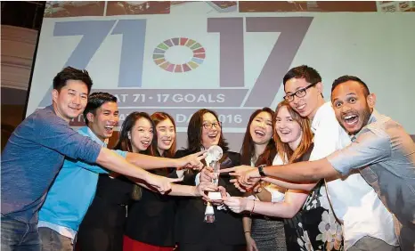  ??  ?? We are the champions: Ian Yee (centre) with some of the R. AGE team members (from left) Elroi Yee, Hansel Khoo, Lim May Lee, Natasha Venner-Pack, Samantha Chow, Claire Gaunt, Julien Chen and Shanjeev Reddy, sharing their joy in winning the award.