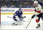  ?? CHRIS O’MEARA — THE ASSOCIATED PRESS ?? Lightning goaltender Andrei Vasilevski­y stops a shot by the Panthers’ Maxim Mamin during Monday’s Game 4.