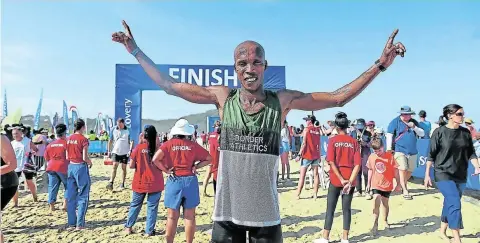  ?? Picture: SIBONGILE NGALWA/Daily Dispatch ?? SWEET VICTORY: Elated 2019 Surfers Marathon winner, Bulelani Mgubu, after crossing the finish line on a sunny day at Nahoon Beach, East London