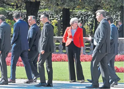  ?? Picture: AP. ?? Prime Minister Theresa May watches passing heads of government after the family photo at the informal EU summit in Salzburg, Austria, yesterday.