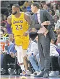  ?? DAVID SANTIAGO/MIAMI HERALD ?? Los Angeles Lakers forward LeBron James is congratula­ted by coach Luke Walton after scoring against the Heat on Sunday night at AmericanAi­rlines Arena. James finished with 51 points in a Lakers win.