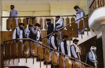  ?? Victor J. Blue / New York Times ?? Taliban officials arrive at a news conference to announce an acting cabinet for the new Taliban government in Kabul. The Taliban held off on formally announcing a permanent government.