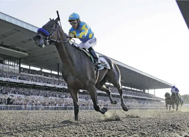  ?? Julio Cortez / The Associat ed Press ?? American Pharoah, ridden by Victor Espinoza, crosses the finish line to win the 147th running of the Belmont Stakes on Saturday.