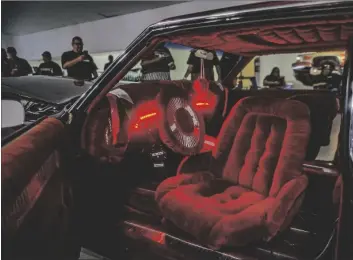  ?? PHOTO VINCENT OSUNA ?? Red LED lights illuminate the swivel bucket seat installed in a Chevy Caprice of Otay Vida Car Club during the La Gente Super Show on Saturday in Imperial.