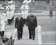  ?? AP ?? North Korean leader Kim Jong Un (right) and Vietnamese President Nguyen Phu Trong attend a welcoming ceremony Friday at the Presidenti­al Palace in Hanoi. Kim is expected to return to North Korea today.