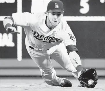  ?? Wally Skalij Los Angeles Times ?? JOSH REDDICK makes a diving catch in right field to save at least one run in the 3rd inning against the Rockies at Dodger Stadium.