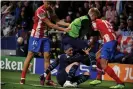  ?? Photograph: Óscar del Pozo/AFP/ Getty Images ?? Phil Foden ends up on the turf as another set-to develops at the Wanda Metropolit­ano.