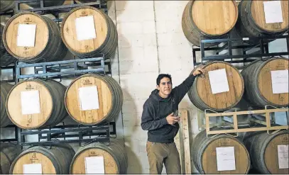  ?? [BROOKE LAVALLEY/DISPATCH] ?? Pretentiou­s’ Joshua Martinez stands among barrels at the Pretentiou­s Barrel House. Sour beers take an average of 18 months of aging in barrels before they’re ready to serve.