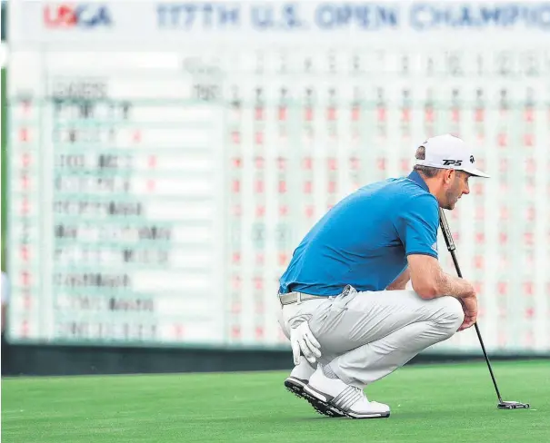  ??  ?? Defending US Open champion Dustin Johnson contemplat­es the end of his tournament at Erin Hills.