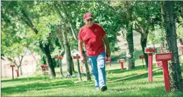  ?? FELIX ADAMO / CALIFORNIA­N FILE ?? Retired U.S. Marine Master Gunnery Sgt. Glenn Denton Jr. walks among the trees planted by volunteers and family members as memorials to individual soldiers, sailors, airmen and Marines at Camp Hamilton north of Bakersfiel­d. Denton was known affectiona­tely as “Master Guns.”