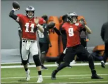  ?? MATT ROURKE — THE ASSOCIATED PRESS ?? Eagles quarterbac­ks Carson Wentz, left, and Nick Foles throw passes during a training camp practice Monday. While Foles is cleared to play Thursday in the preseason rematch of Super Bowl LII, Wentz’s way back to game minutes is taking longer.