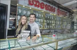  ?? Brian van der Brug Los Angeles Times ?? SERINA LIM, left, and Tarith Tan reopened Phnom Pich Jewelry Internatio­nal in Long Beach after months of closure. “We’ve depleted our savings,” Lim said.