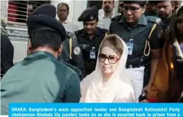  ??  ?? DHAKA: Bangladesh’s main opposition leader and Bangladesh Nationalis­t Party chairperso­n Khaleda Zia (center) looks on as she is escorted back to prison from a hospital visit in Dhaka. —AFP