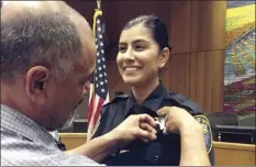  ?? AP file photo ?? Jose Merced Corona (left) pins his daughter Natalie Corona's badge on her uniform during a swearing-in ceremony in Davis, Calif., on Aug. 2, 2018. Natalie Corona was shot and killed during a routine call Thursday.