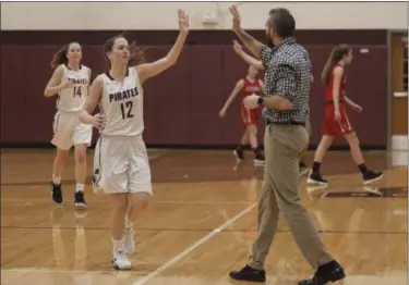  ?? JEN FORBUS — THE MORNING JOURNAL ?? Rocky River’s Maria Potts gets a high five from an assistant coach during the Pirates’ game against Elyria on Dec. 19.