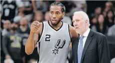  ??  ?? Kawhi Leonard, seen with Spurs coach Gregg Popovich, is skipping Team USA camp to focus on his transition to the Toronto Raptors.