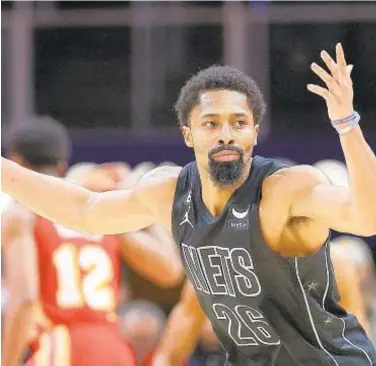  ?? PHOTOS BY GETTY ?? Spencer Dinwiddie and Nets have no answer for Hawks star Trae Young (opposite page), who hits game-winning shot as time expires Sunday afternoon in Atlanta.