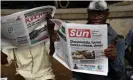  ??  ?? A man reads a newspaper with a frontpage story about the appointmen­t of Ngozi Okonjo-Iweala as WTO president, in Ibadan, Nigeria. Photograph: Pius Utomi Ekpei/AFP/ Getty