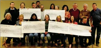  ??  ?? Elber Twomey and the fundraisin­g team proudly hold up the cheques which has been given to charities as a result of the fifth Twomey Family Remorial.