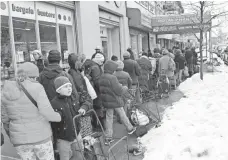  ?? SPENCER PLATT, GETTY IMAGES ?? People wait in line for food in Brooklyn on Feb. 18.