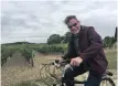  ??  ?? JOHNNY Clegg riding a borrowed bicycle through the vineyards near Tours in France in 2016. | ANDY INNES