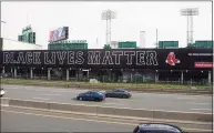  ?? Kathryn Riley / TNS ?? A Black Lives Matter billboard is displayed over the Massachuse­tts Turnpike on Opening Day at Fenway Park in 2020 in Boston.