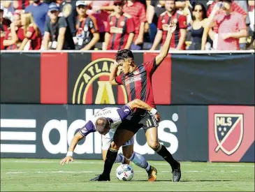  ?? PHOTOS BY MIGUEL MARTINEZ / MUNDO HISPANICO ?? Atlanta United’s Yamil Azad battles a falling Orlando City player at Bobby Dodd Stadium. Orlando City appeared destined to win until Atlanta United scored during injury time.