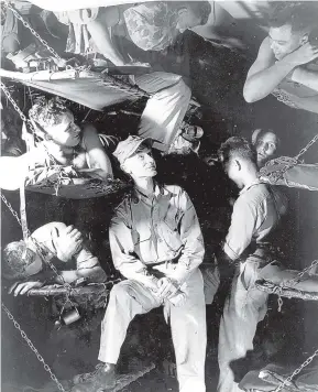  ?? ASSOCIATED PRESS ?? Journalist Ernie Pyle chats with Marines aboard a U.S. Navy transport in March 1945, while en route to the invasion of Okinawa. Pyle was killed the following month on the island of Ie Shima after being hit by machine-gun fire.