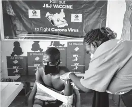  ?? LYNSEY ADDARIO/THE NEW YORK TIMES 2021 ?? Alorovicto­r Bernard, 24, receives an inoculatio­n in South Sudan, which has administer­ed thousands of vaccine shots donated from the U.S.