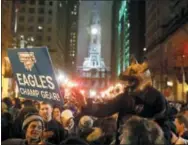  ?? MATT ROURKE — THE ASSOCIATED PRESS ?? Eagles fans celebrate Super Bowl victory early Monday morning in downtown Philadelph­ia.