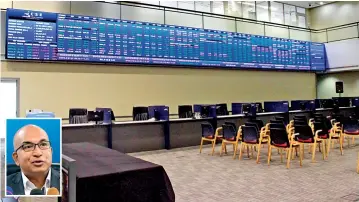  ?? Pix by Indika Handuwela ?? Empty floor of the Colombo Stock Exchange (CSE) which was closed this week due to the uncertain political situation. (Inset) CSE Chairman Dumith Fernando speaking to reporters.