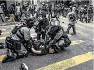  ?? Dale de la Rey / AFP via Getty Images ?? Pro-democracy protesters on Wednesday launched a campaign of roadblocks and vandalism across Hong Kong that crippled the city for the third straight day.