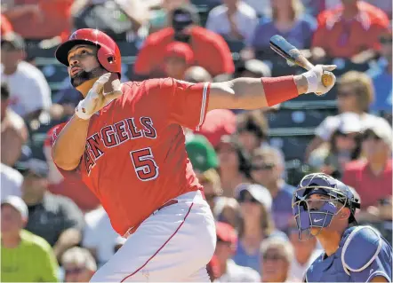  ?? MATT YORK/THE ASSOCIATED PRESS ?? The Angels’ Albert Pujols follows through on a solo home run against the Dodgers during a spring training game March 13 in Tempe, Ariz. Going into the 45th season since the designated hitter was approved by owners for the American League, more managers...