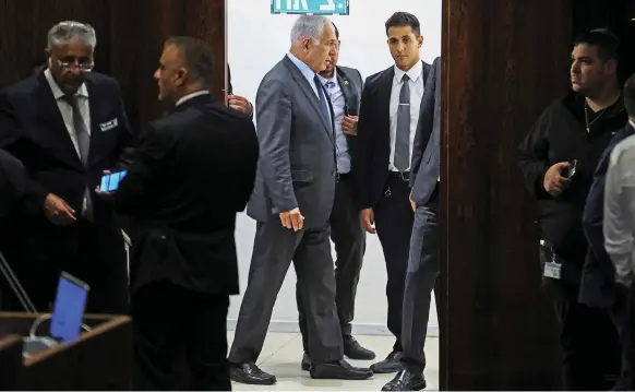  ?? Reuters ?? Israeli Prime Minister Benjamin Netanyahu attends a meeting at the Knesset amid demonstrat­ions. He later announced a delay to proposed judicial reforms