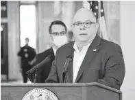  ?? PAMELA WOOD/BALTIMORE SUN ?? Gov. Larry Hogan announces a new series of executive orders Wednesday, including mandating face masks in businesses and on mass transit. He did not address school closures.